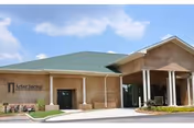 Exterior view of Arbor Springs Health and Rehab Center with brick facade and covered entrance.