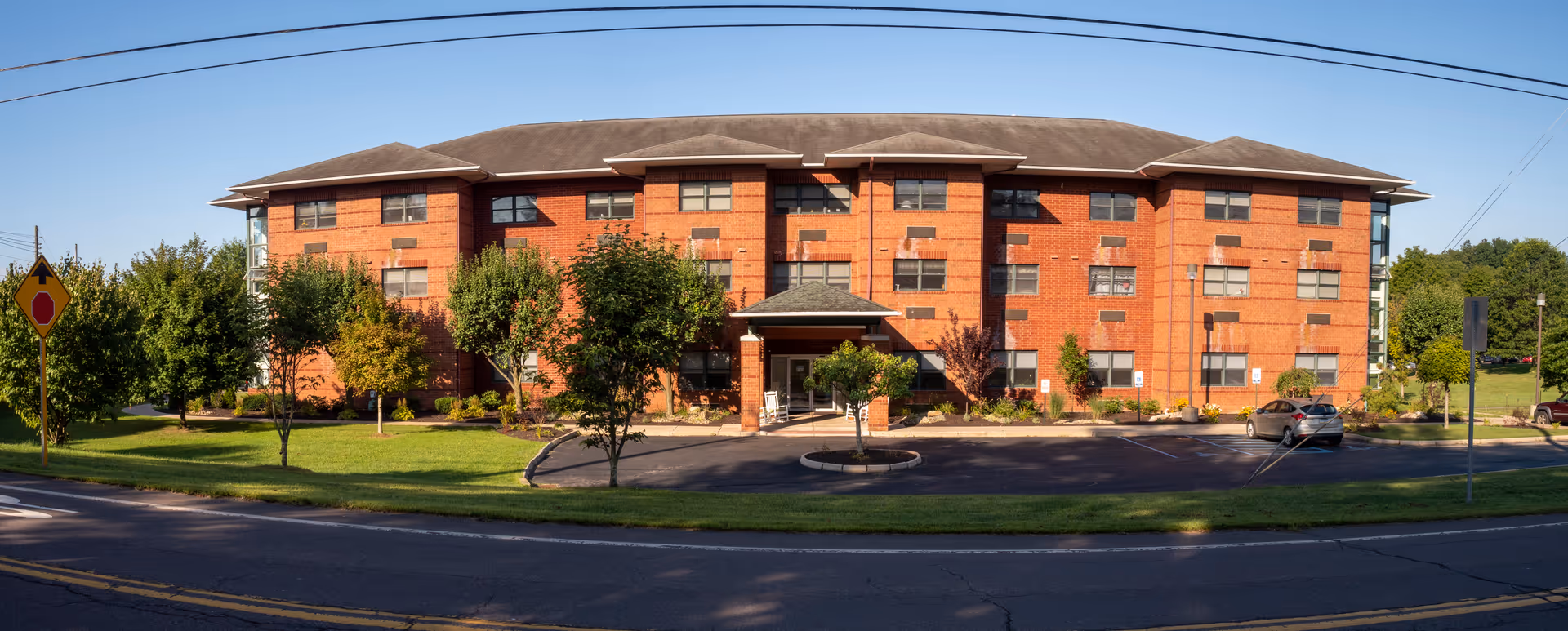 Meadows Manor assisted living building, brick exterior with front entrance and landscaped surroundings.