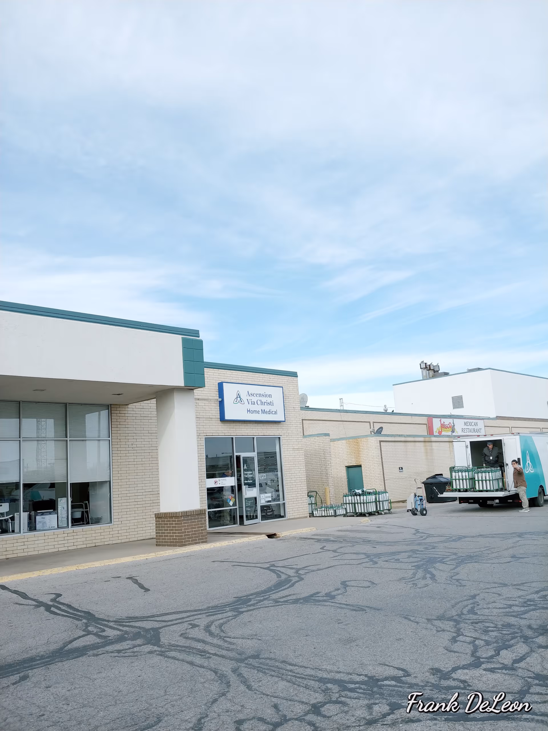 Exterior view of Ascension Via Christi Home Medical storefront with parking lot and delivery truck.
