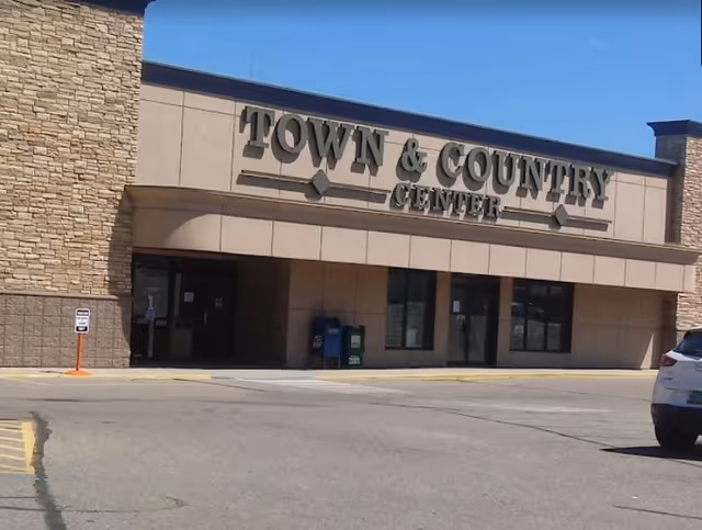 Front exterior of a shopping center with a Town & Country Center sign.