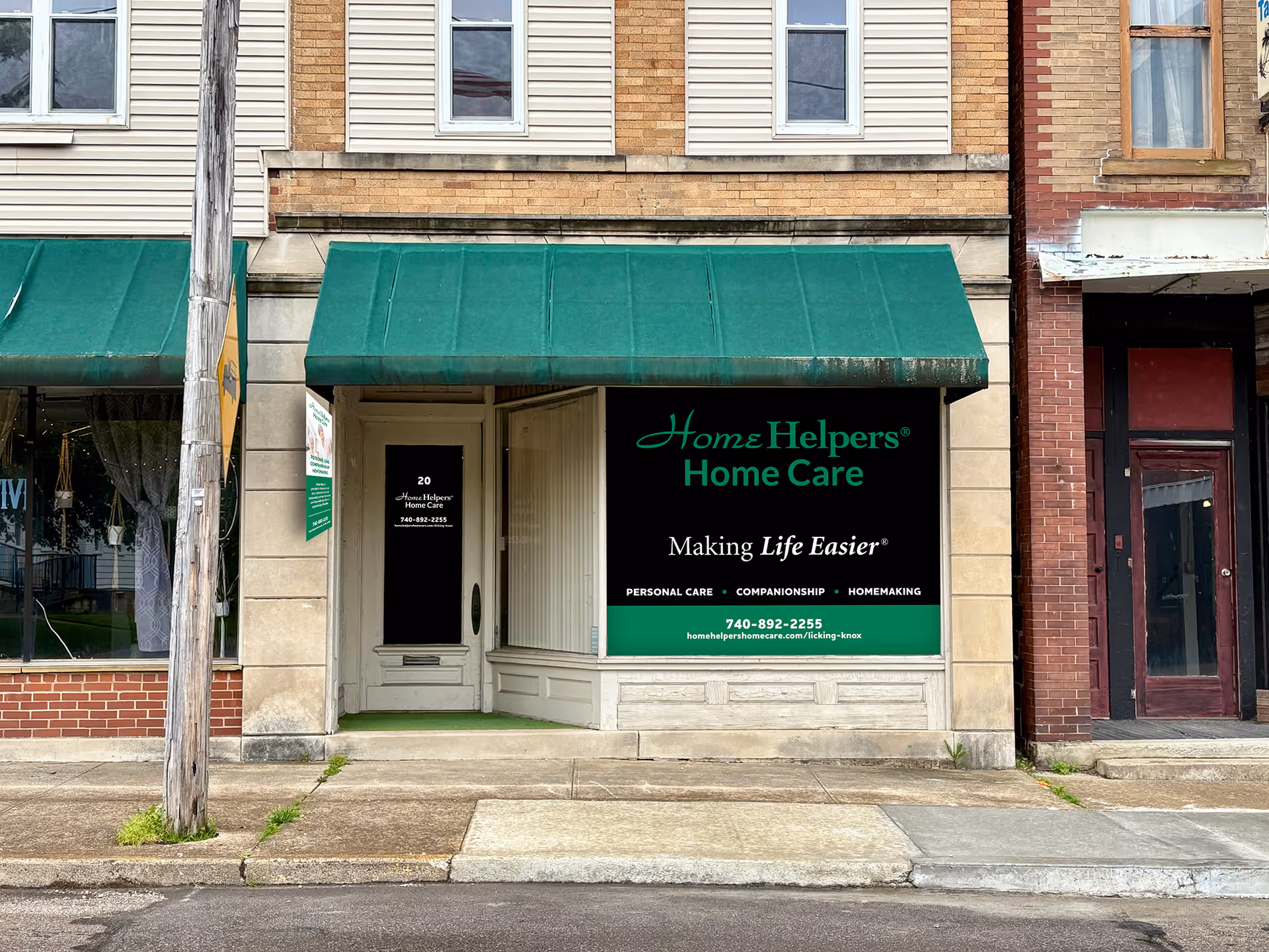 Exterior storefront for Home Helpers Home Care with green awning.