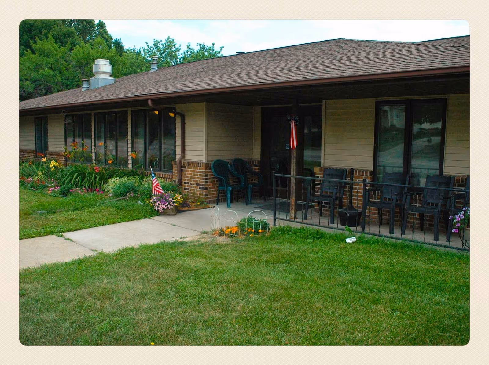 Exterior view of Evergreen Estates I with a covered porch and outdoor seating.
