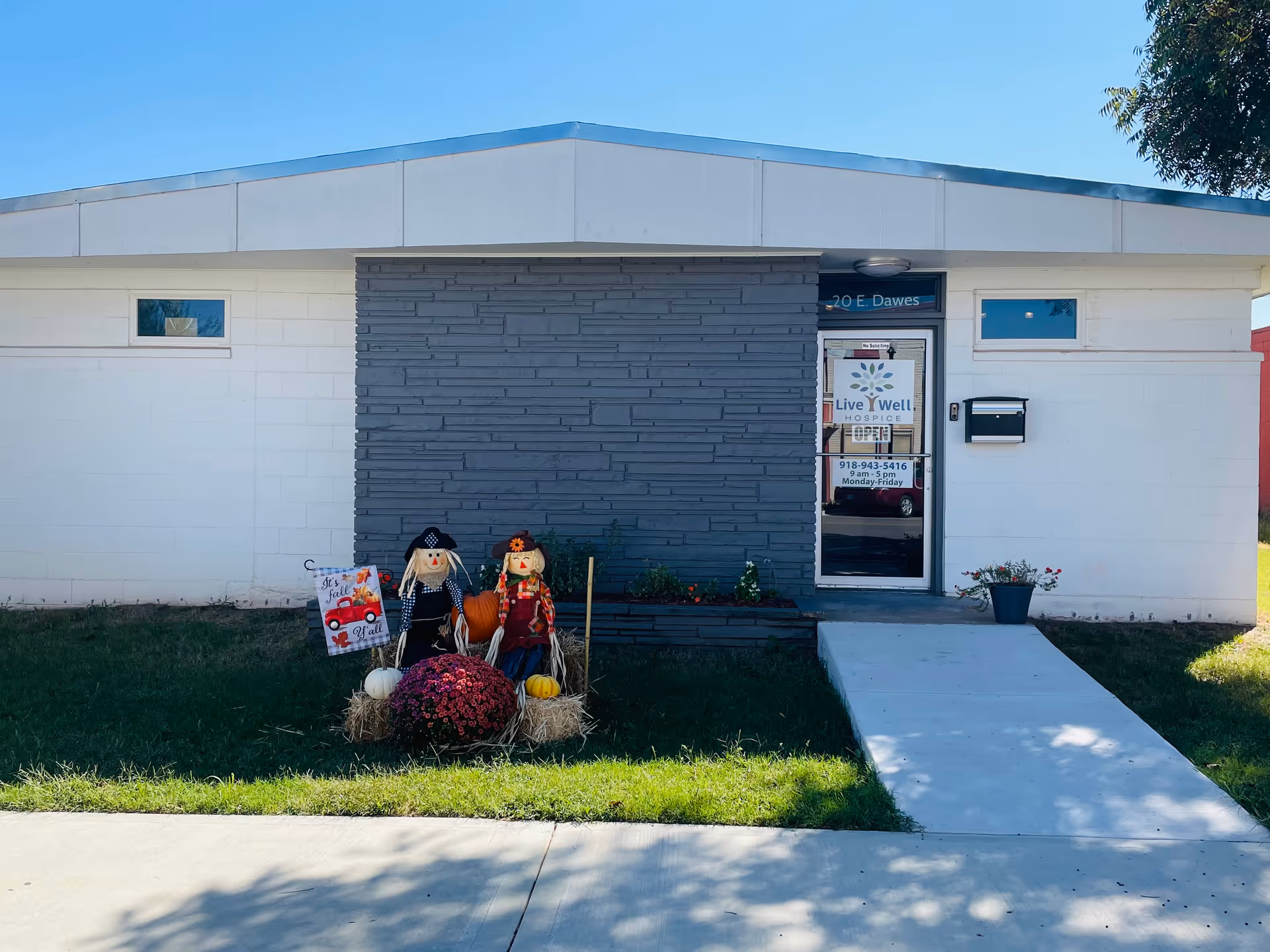 Front exterior of Live Well Hospice building with Halloween decor