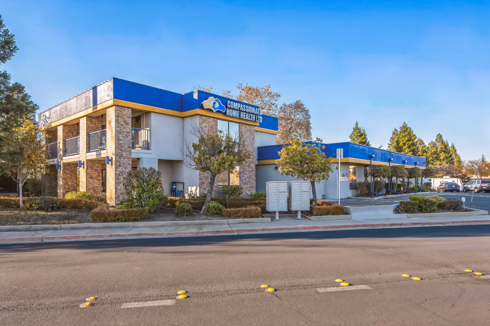 Exterior view of Compassionate Home Health Ltd building with blue trim and parking