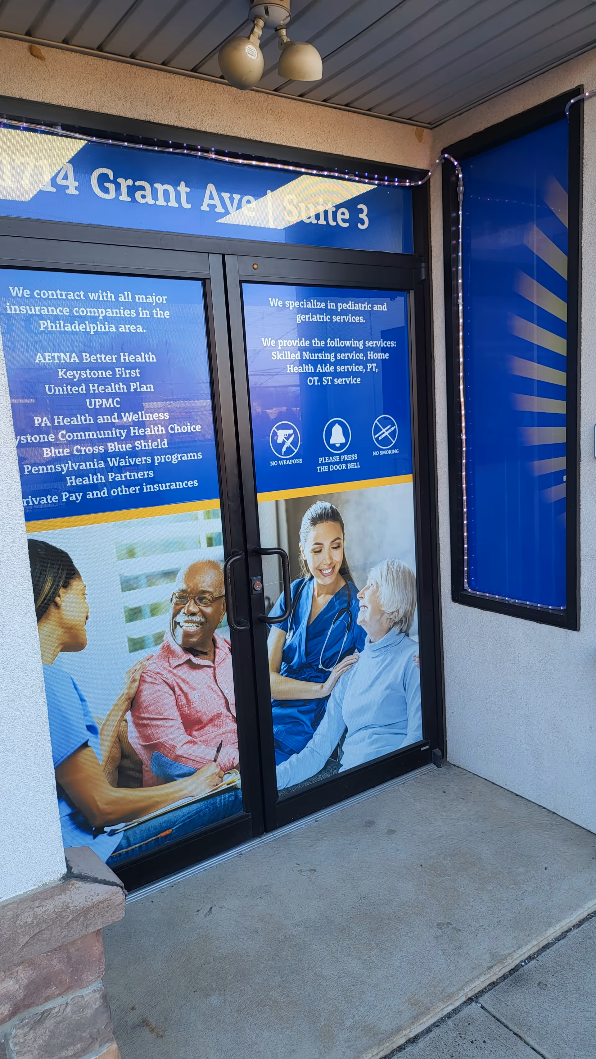 Entrance doors to Amazing Care Home Health Services with blue promotional posters.