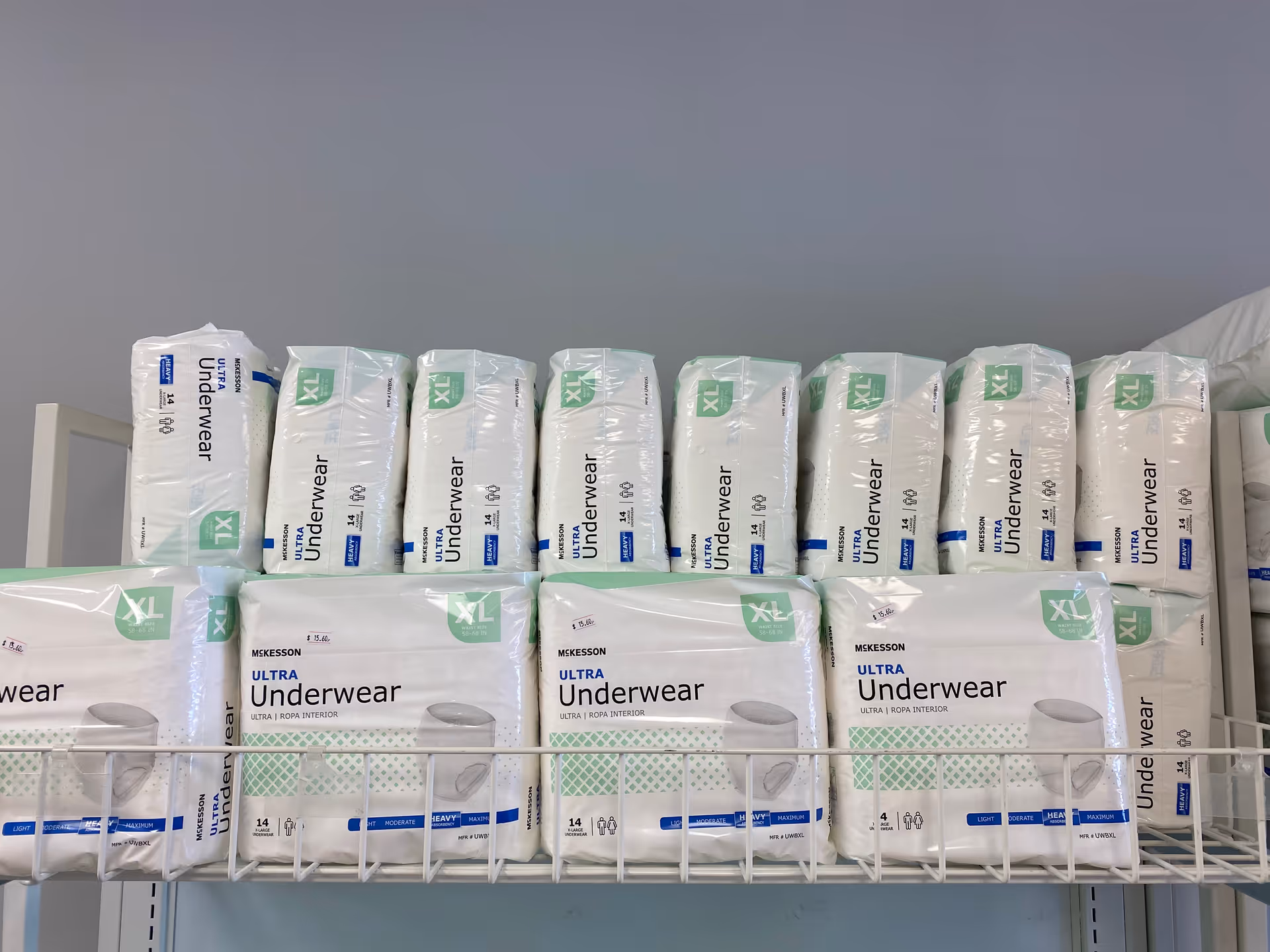 Stacks of XL Ultra Underwear packages on metal shelves in a storage room.
