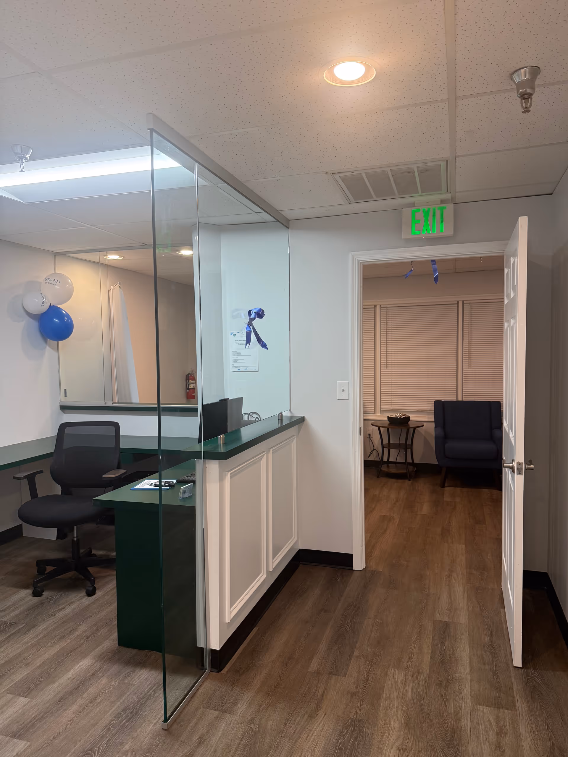 Reception area of a senior care facility with glass partition and exit door