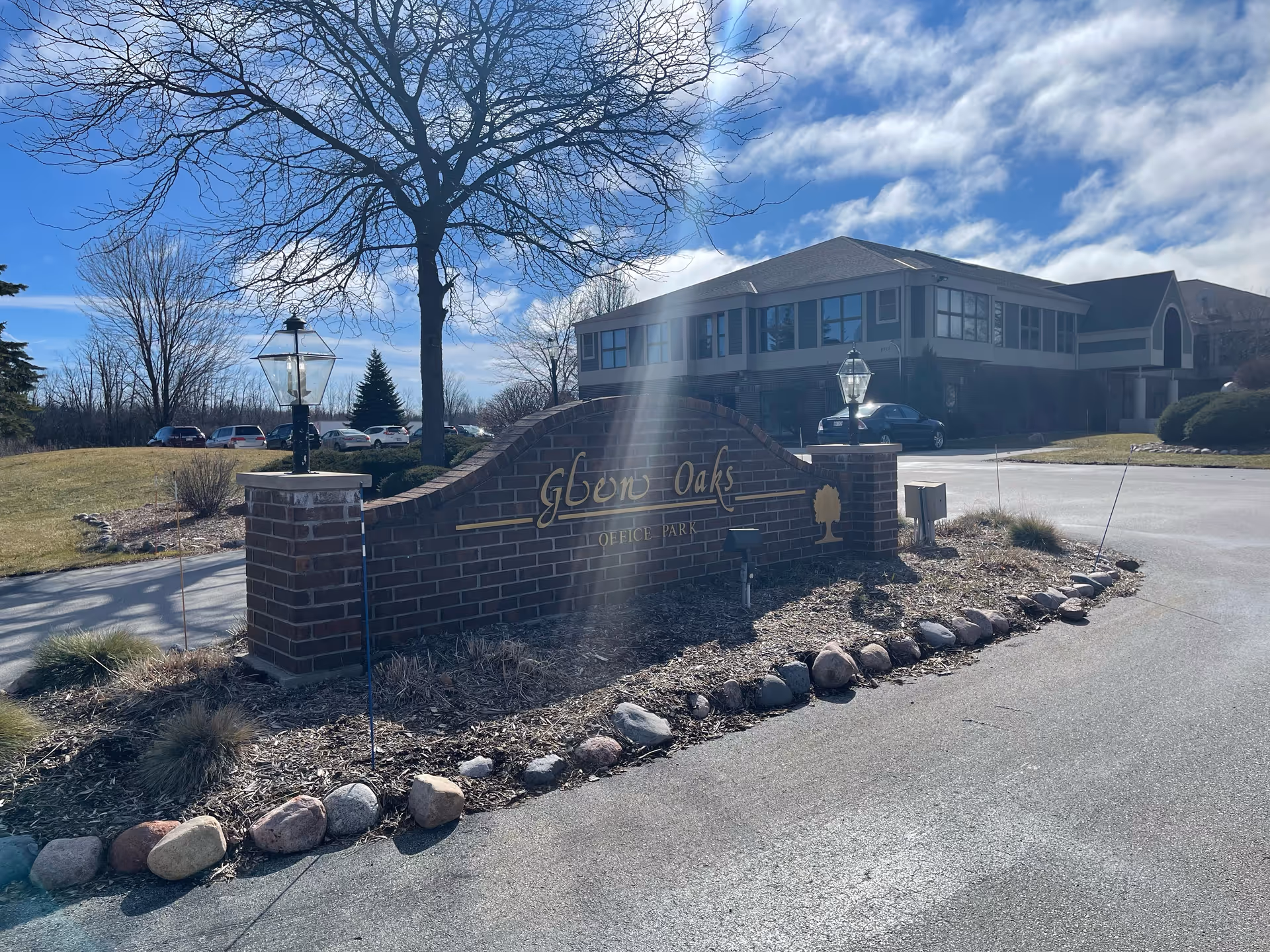 Exterior view of Glen Oaks facility with brick entrance sign