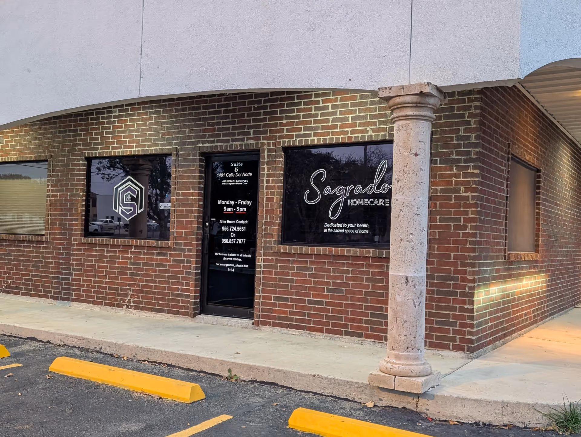 Brick storefront with Sagrado Homecare signage, glass door, and adjacent windows