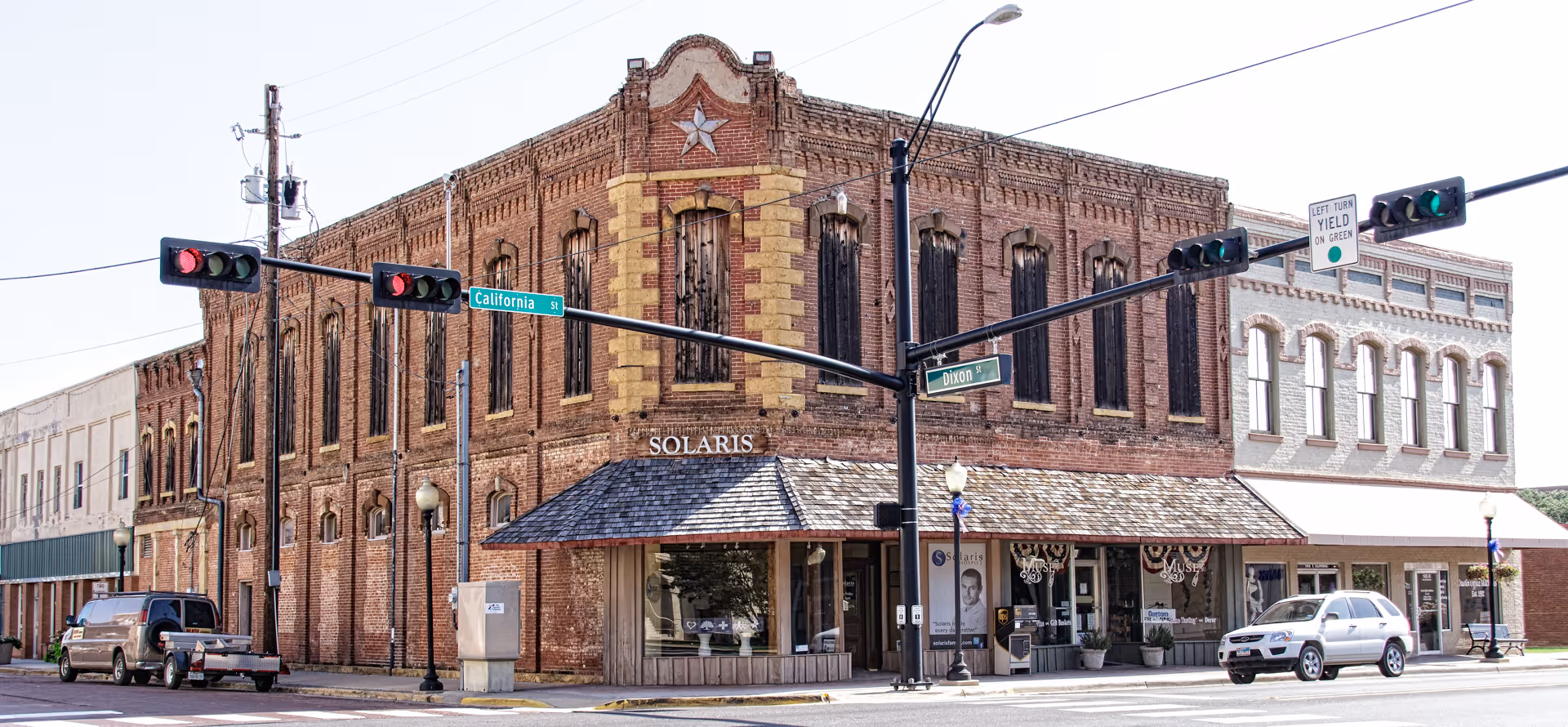 Brick Solaris Healthcare building sits at a street corner with storefront windows.