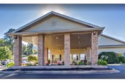 Exterior view of The Waters of Roan Highlands entry with brick columns and covered drop-off.