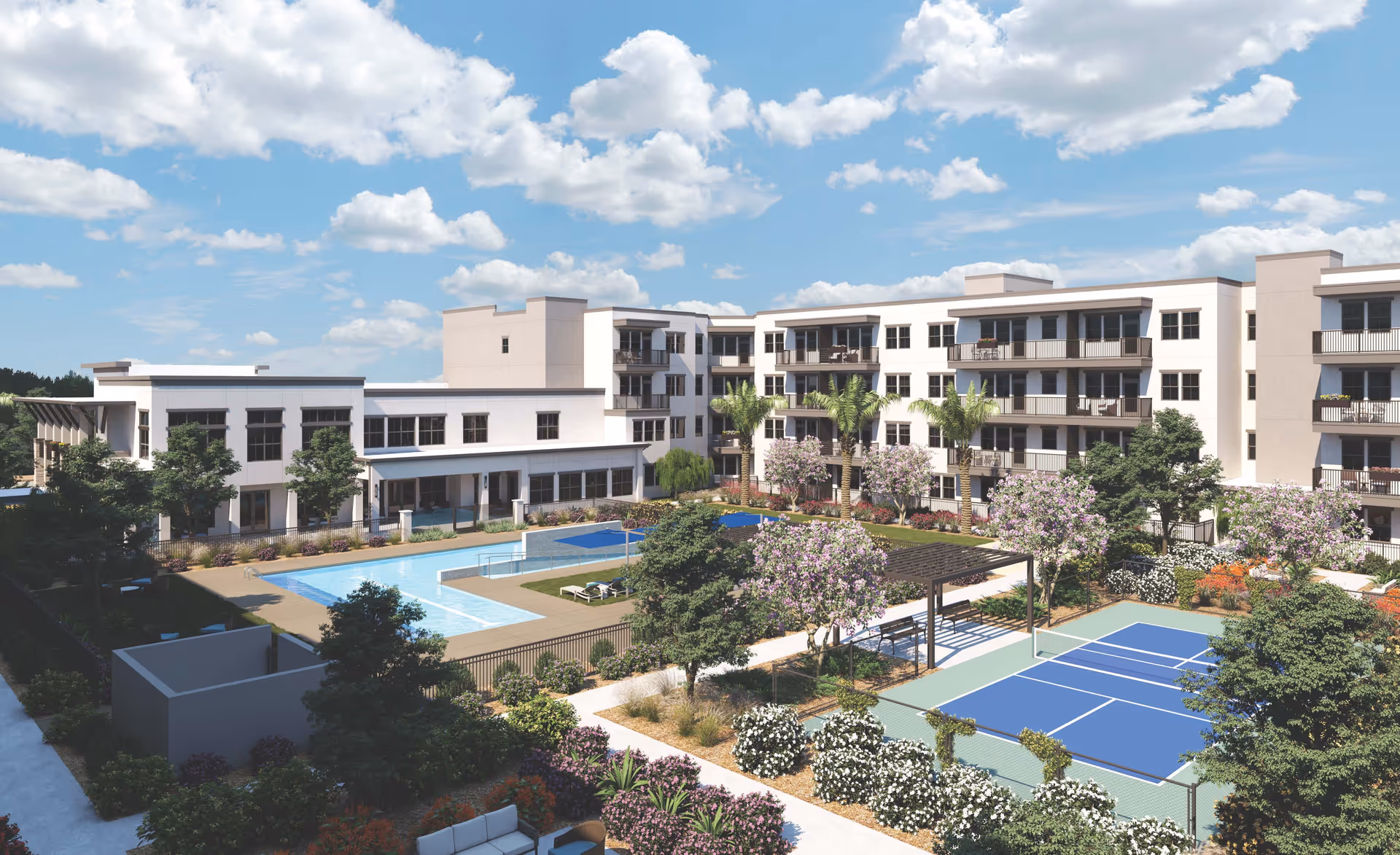 Outdoor view of Mera Westgate senior living facility showing a large swimming pool, tennis court, landscaped gardens with flowering trees and shrubs, and a multi-story building with balconies under a partly cloudy sky.