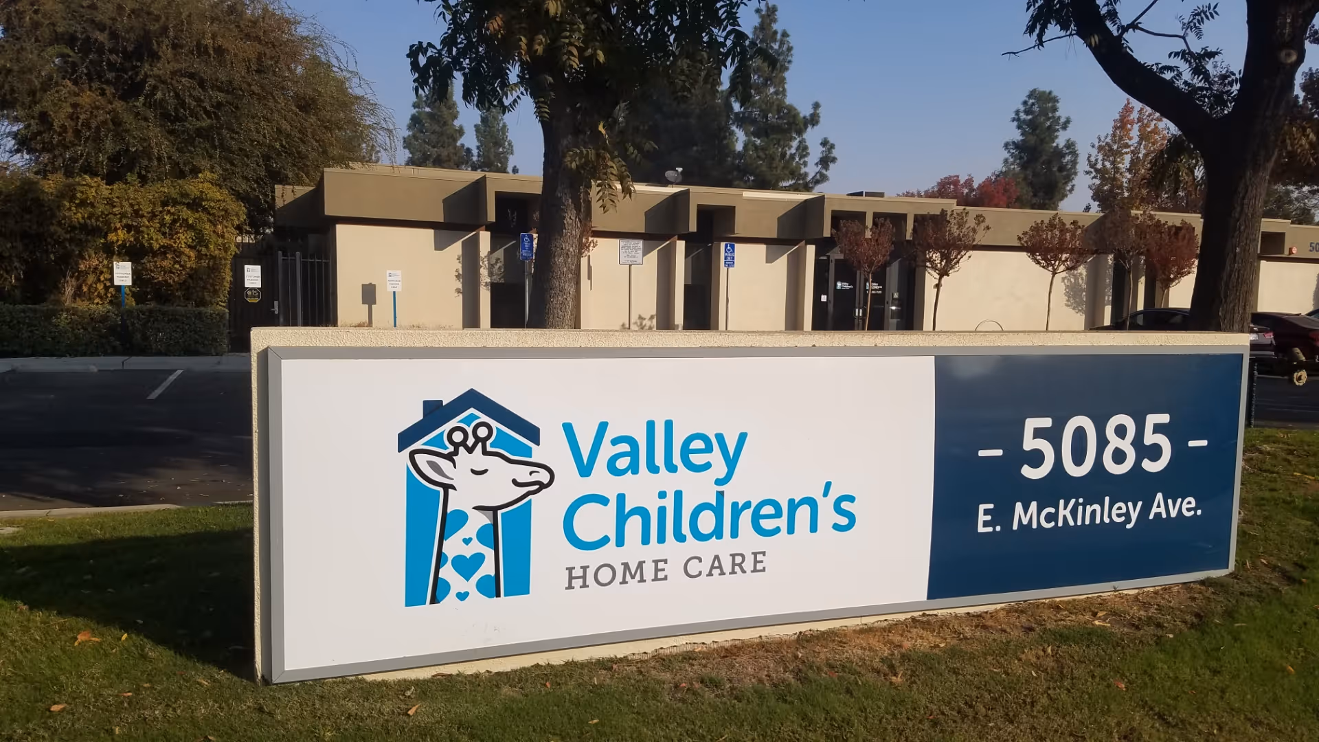 A large outdoor sign for Valley Children's Home Care in front of a low building.