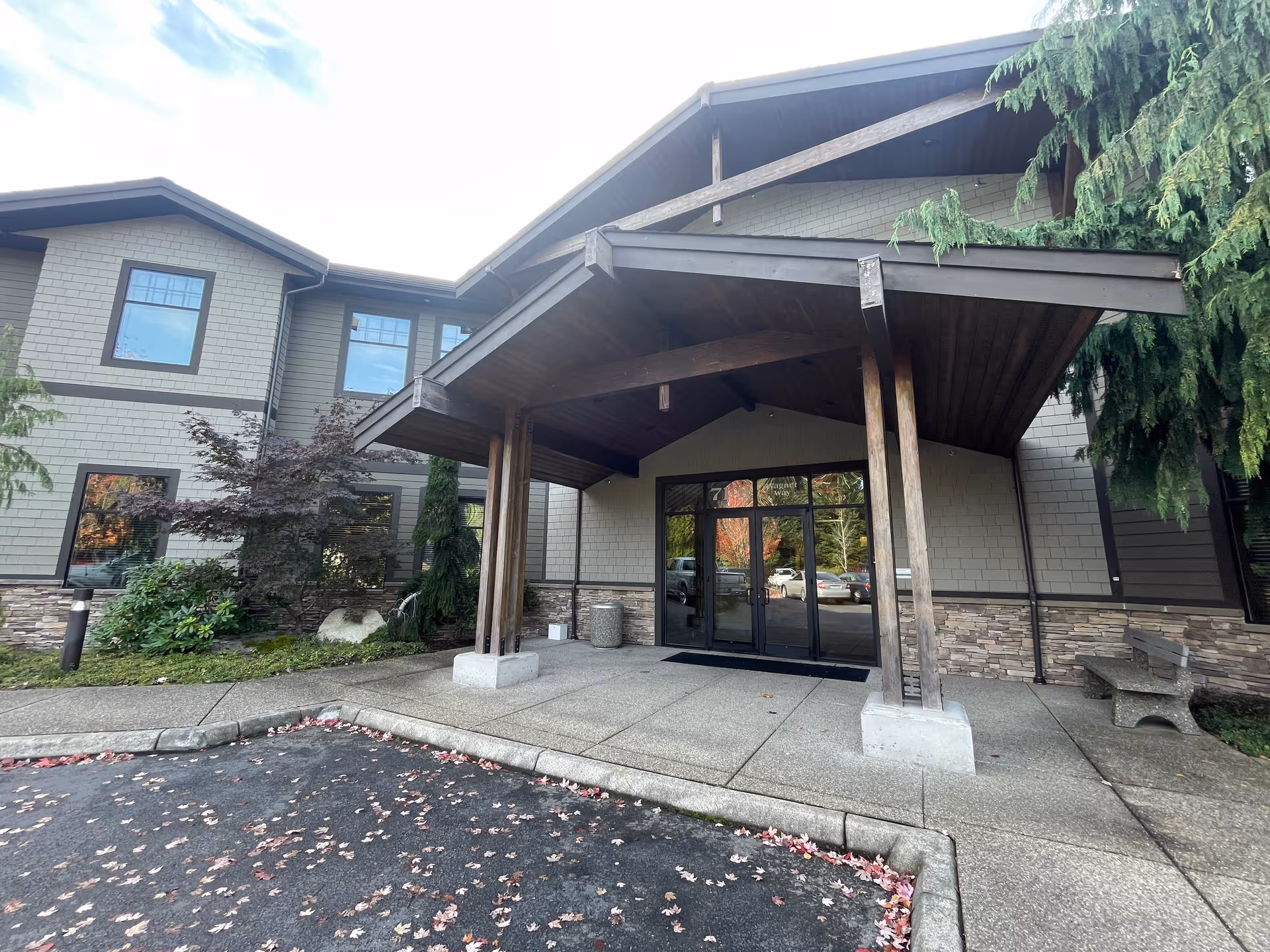 Front entrance of a senior living facility with a covered entryway.