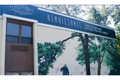Front exterior of Renaissance Healthcare and Rehabilitation Center with green awning sign and mural on wall.
