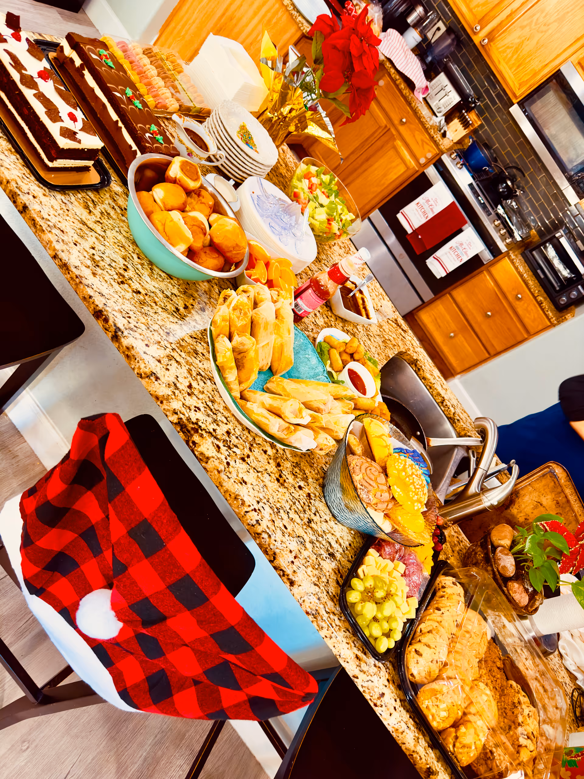 Assorted pastries, fruits, and dishes arranged on a granite kitchen island.
