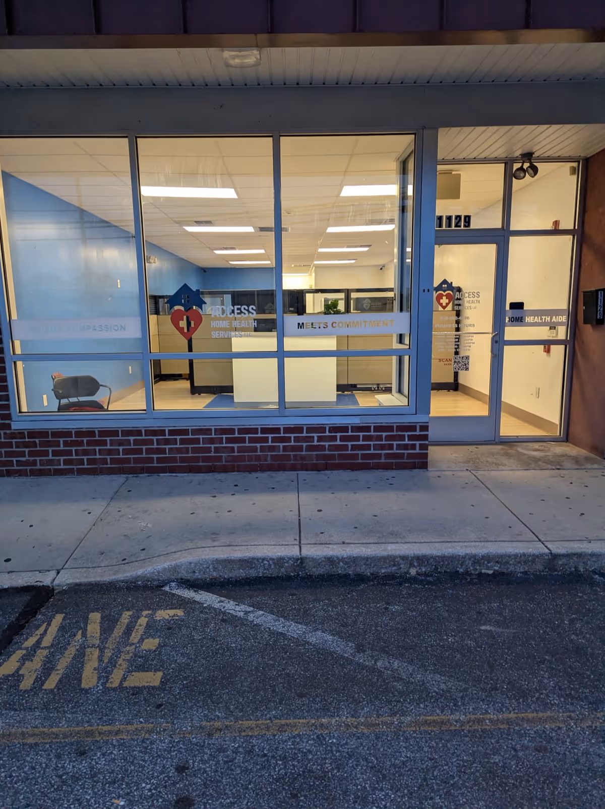 Front view of a glass storefront for Access Home Health Services with interior offices visible.