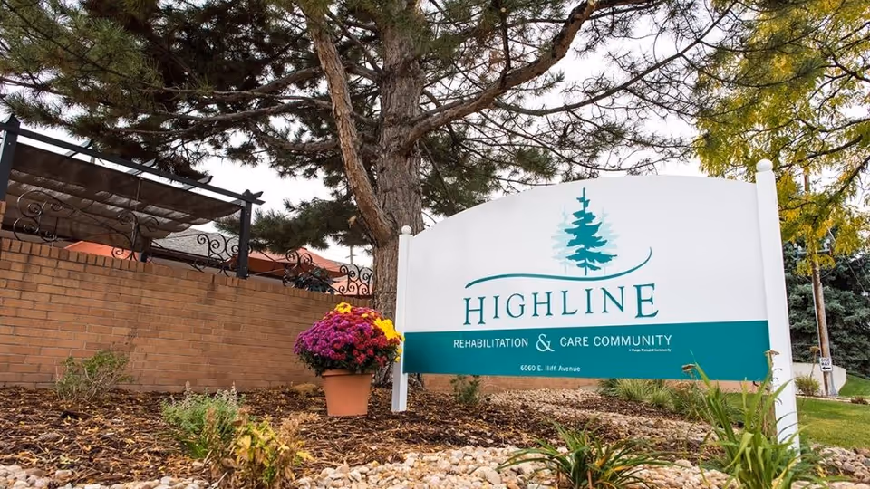 Outdoor view of a Highline Rehabilitation & Care Community sign with landscaping.