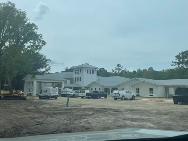 Exterior view of The Canopy at Duval Station under construction with parked vehicles.