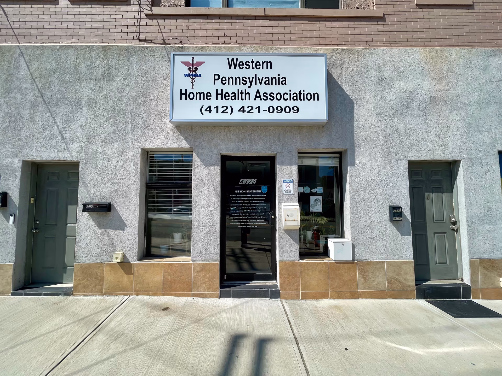 Facade of a gray storefront with a sign reading Western Pennsylvania Home Health Association.