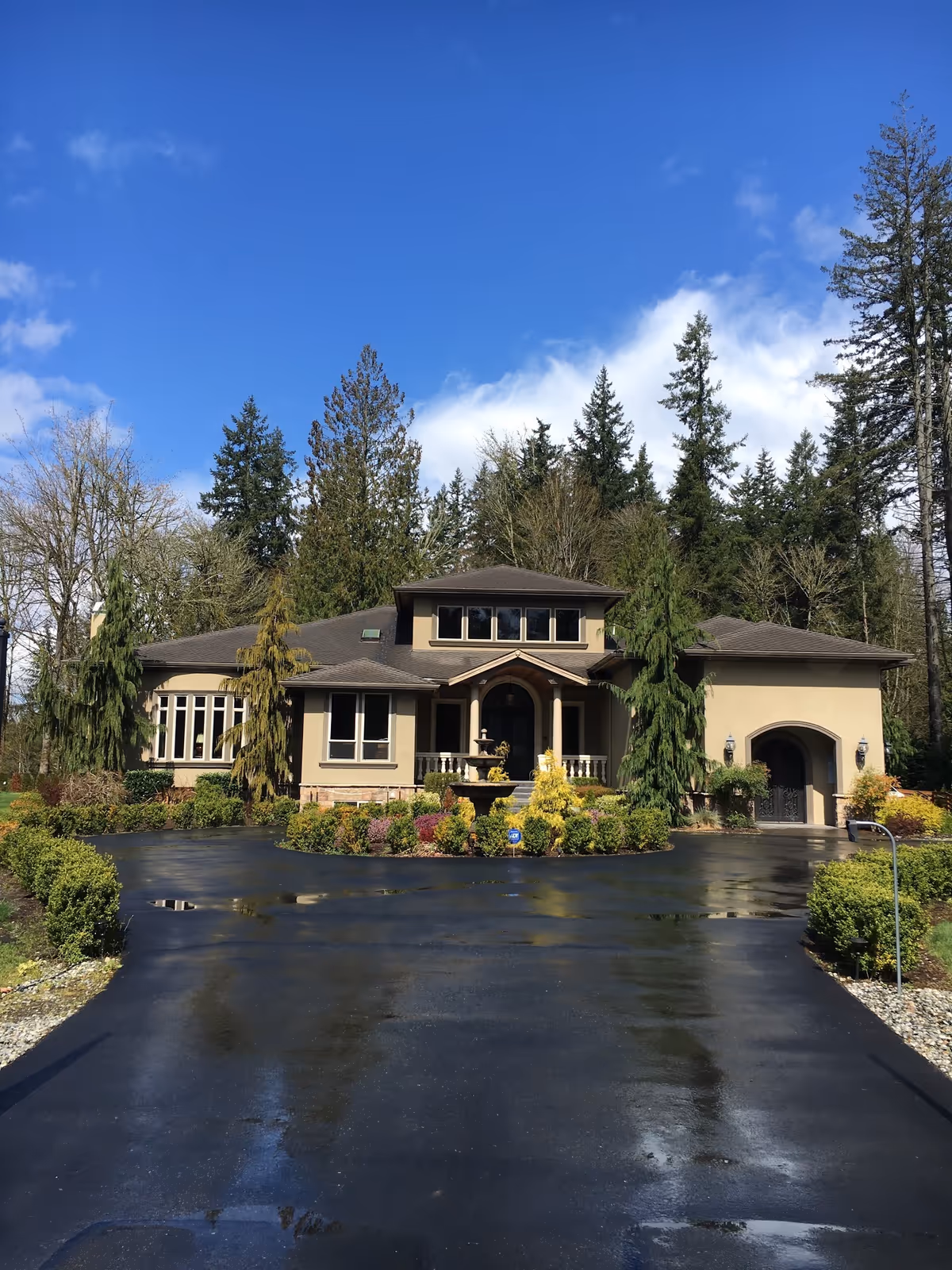 Exterior view of Union Hill Senior Care's beige building with a fountain and circular driveway.