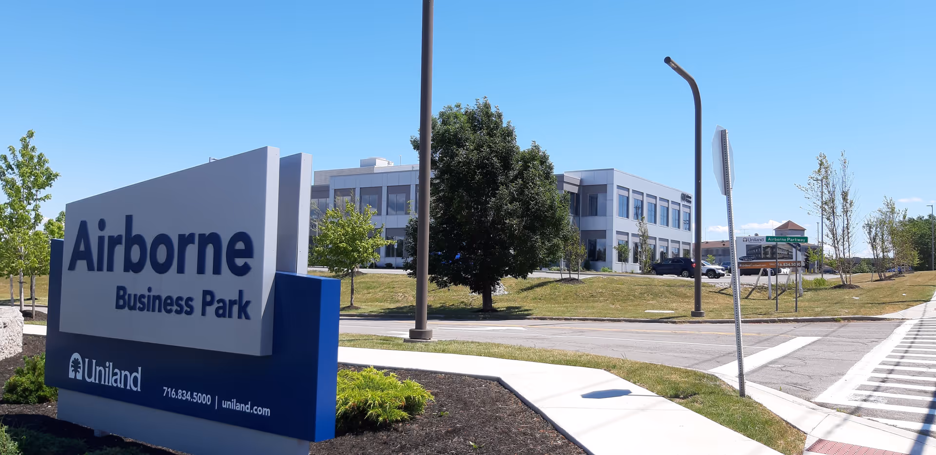 Exterior view of a modern office building with a large Airborne Business Park sign.