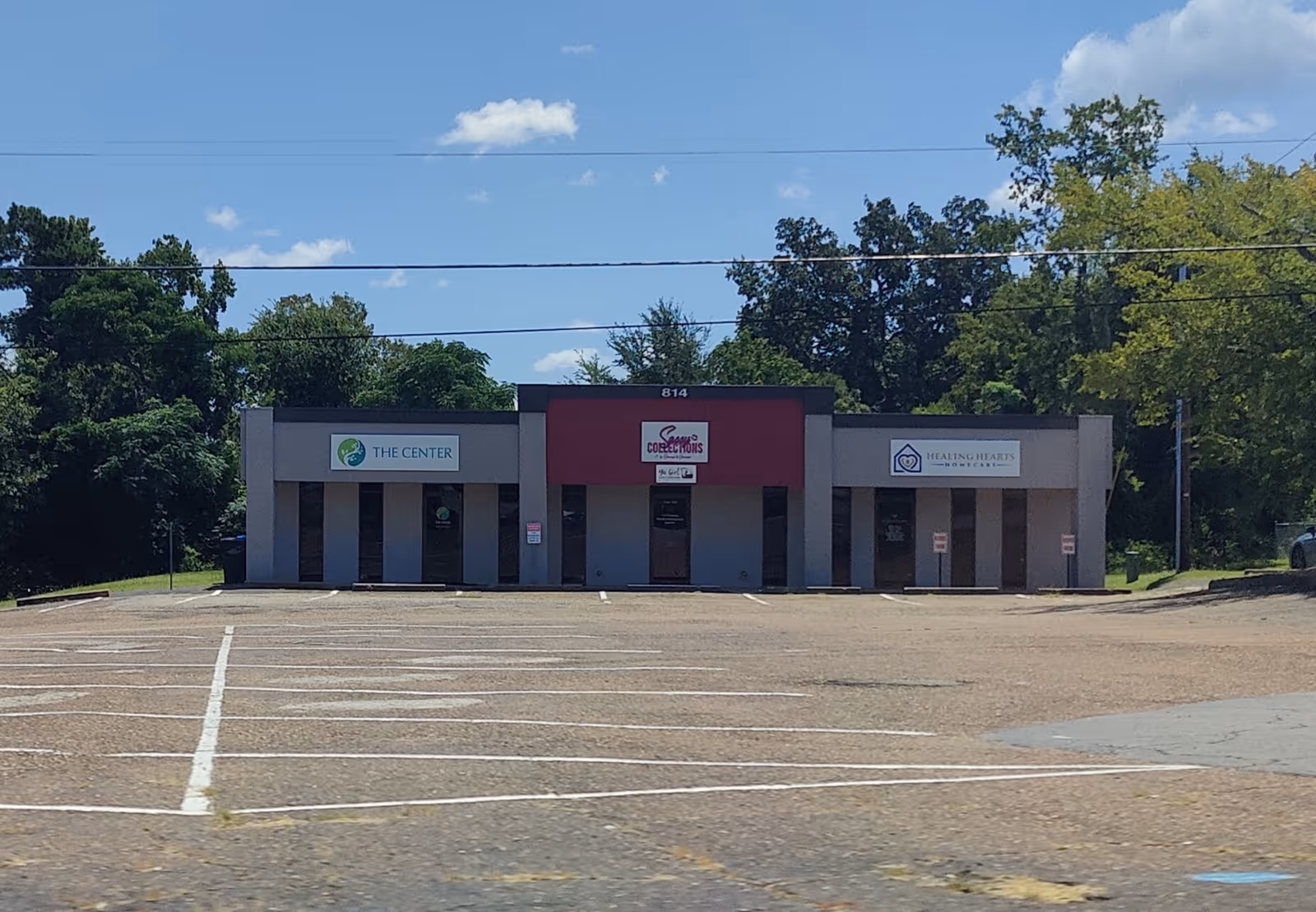 Exterior of a storefront building with Healing Hearts Homecare sign beside other offices.