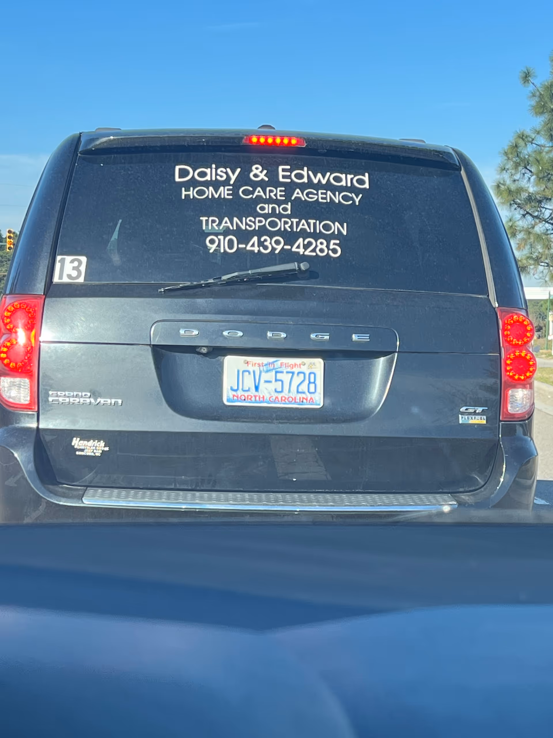 Rear of a dark van displaying Daisy and Edward Home Care Agency lettering.