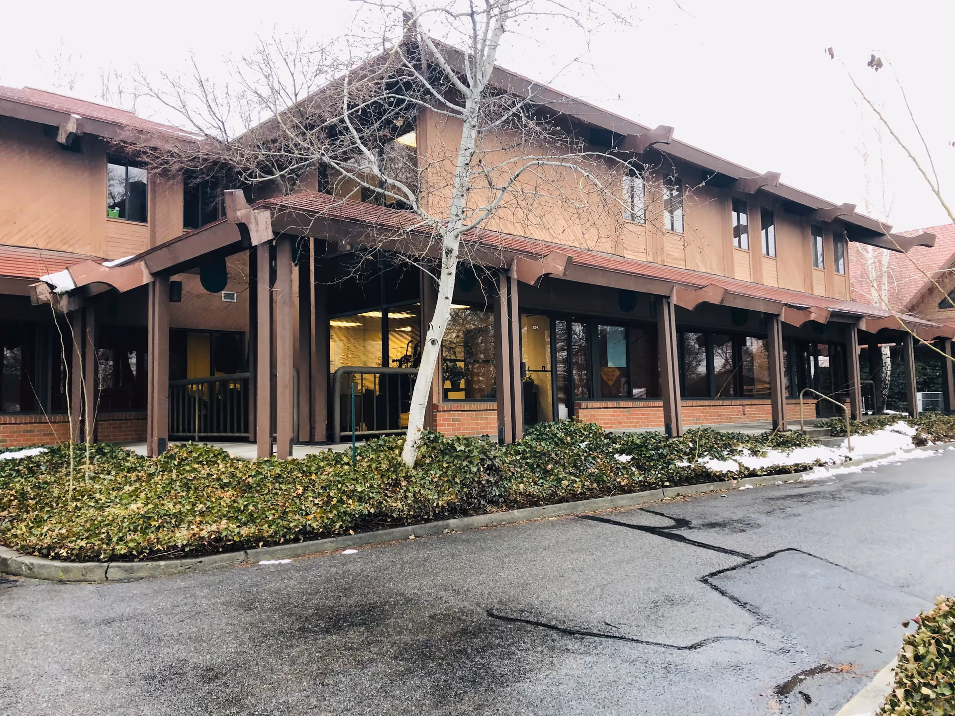 Exterior view of Alternative Nursing Services, Inc. building with glass storefront and entrance.
