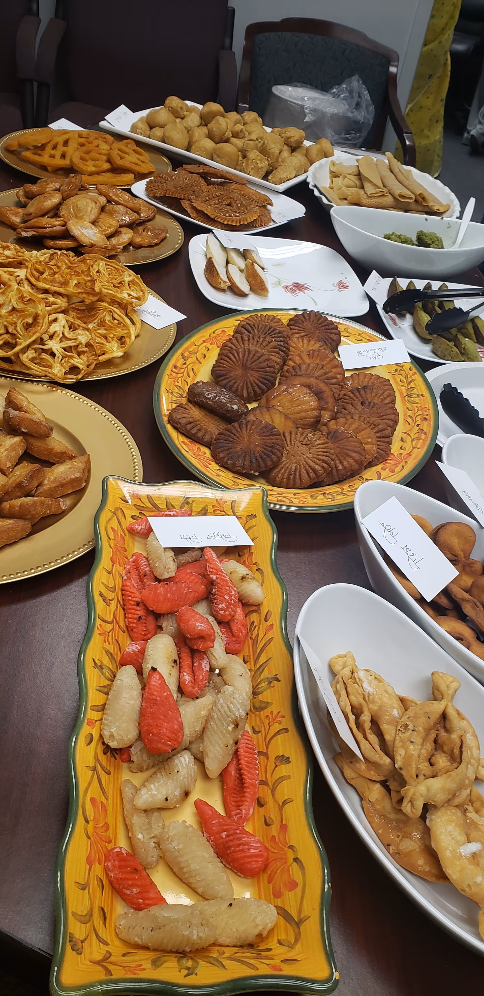 Assorted snacks and pastries arranged on a long dining table.