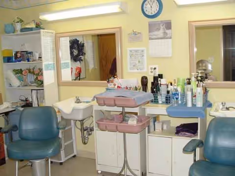 Interior grooming area in a senior facility with chairs, mirrors, and product shelves.