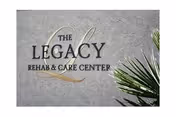 Sign reading The Legacy Rehab & Care Center on a textured wall with green palm fronds.