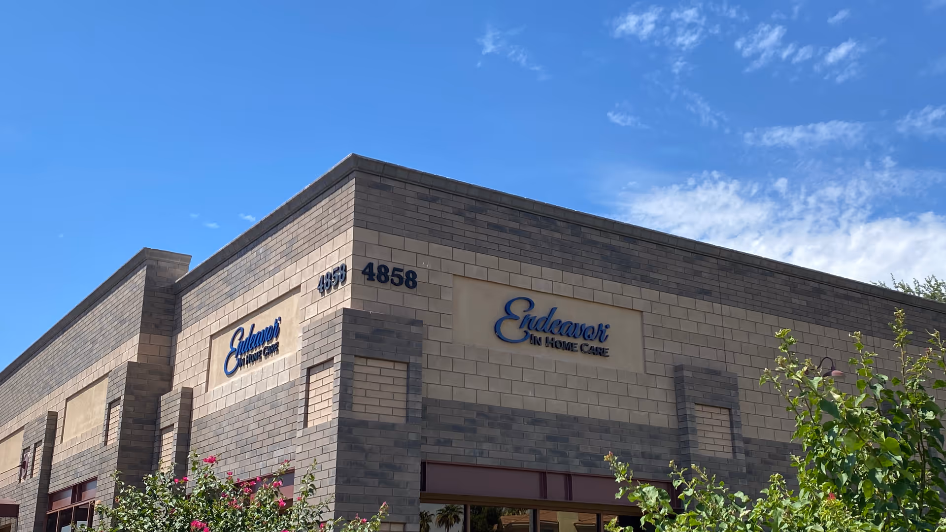 Exterior view of Endeavor In Home Care building with signage and greenery.
