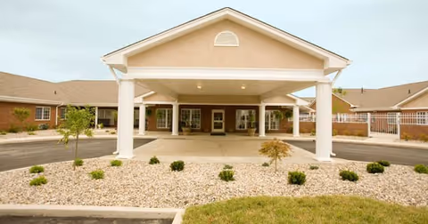 Front view of Greenleaf Health Campus entrance with porte-cochere and landscaped circular drive.