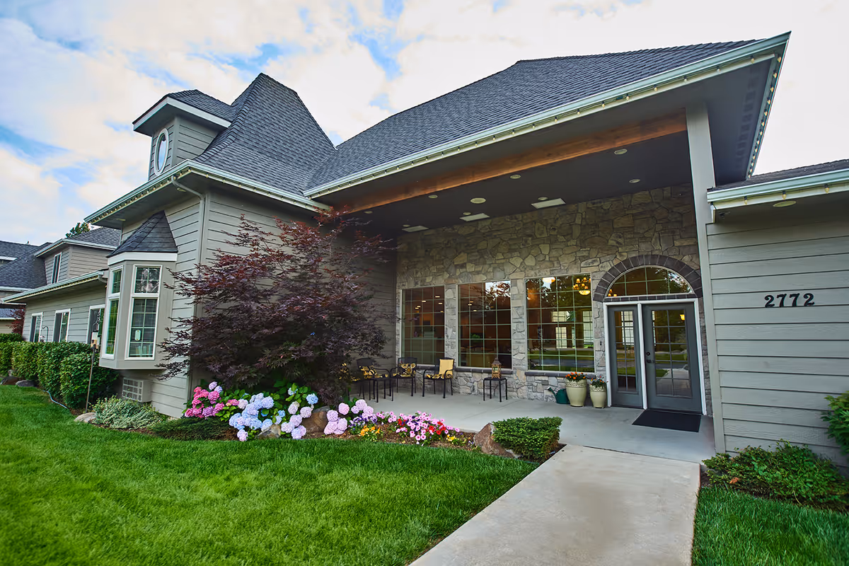 Front exterior of The Renaissance at Coeur D'Alene with stone facade and seating area.