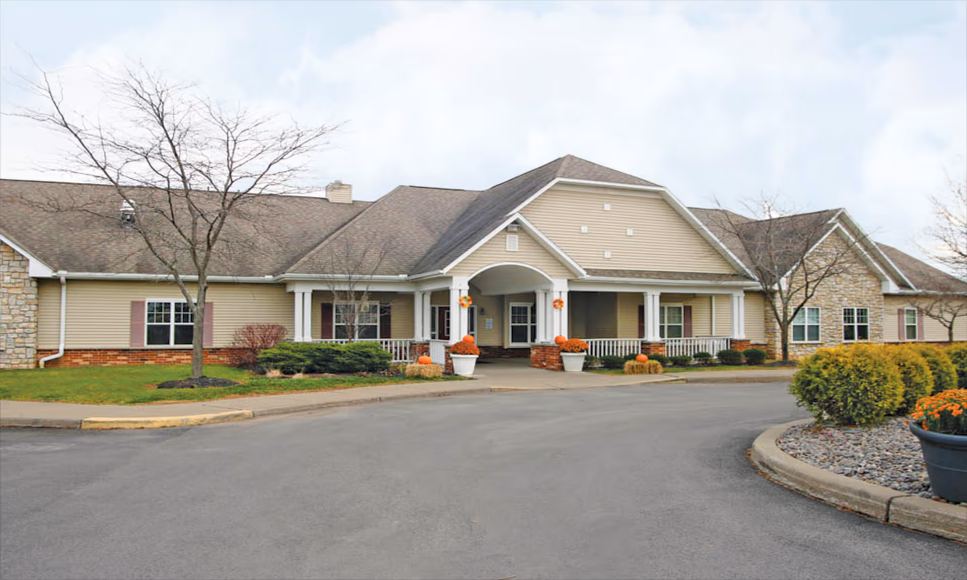 Exterior view of Above and Beyond Adult Family Home, showing the entrance and surrounding landscaping.
