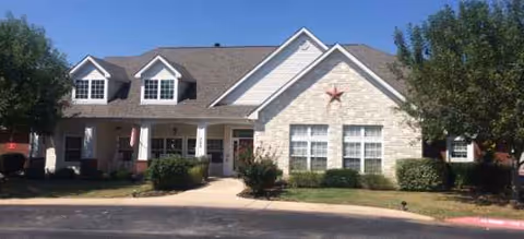Exterior view of Brookdale Kerrville senior living facility with stone facade and landscaping.