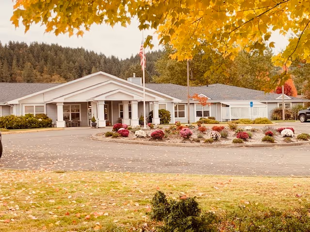 Exterior view of Applegate Place senior living facility with a circular driveway.
