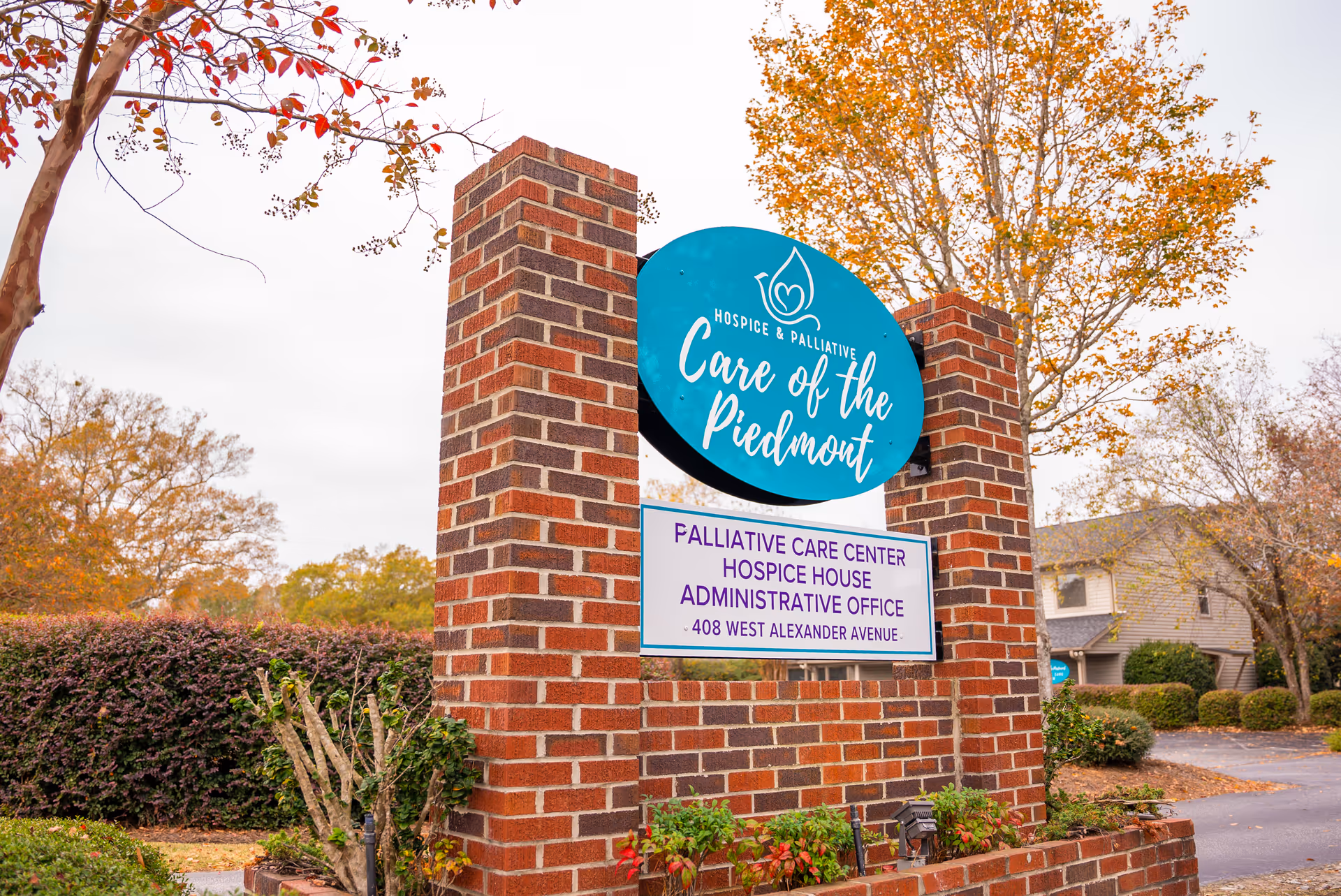 Brick entry sign with teal circular logo for Hospice and Palliative Care of the Piedmont.