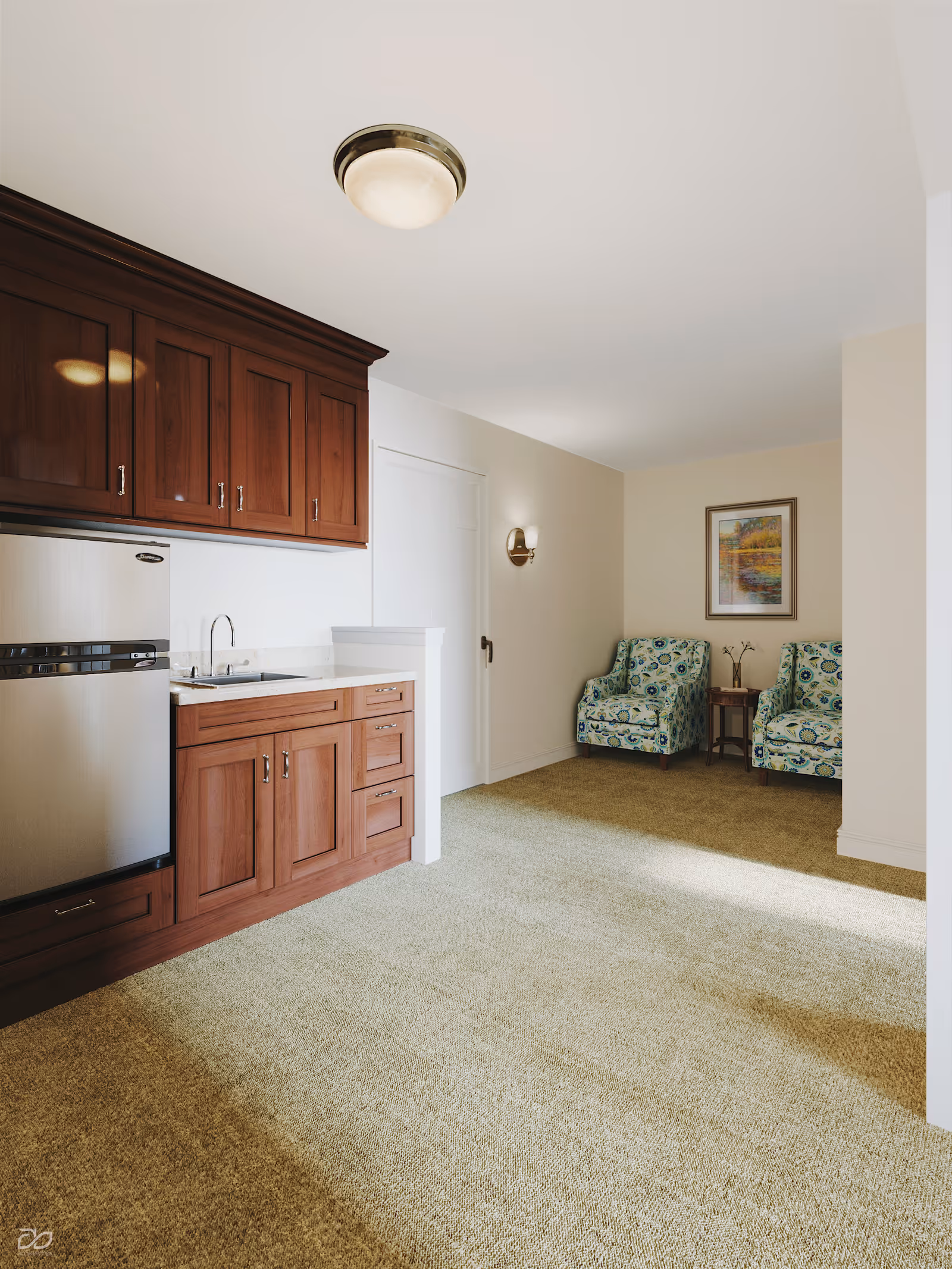Interior kitchenette with wooden cabinetry, stainless appliances, and a small seating area in the living space.