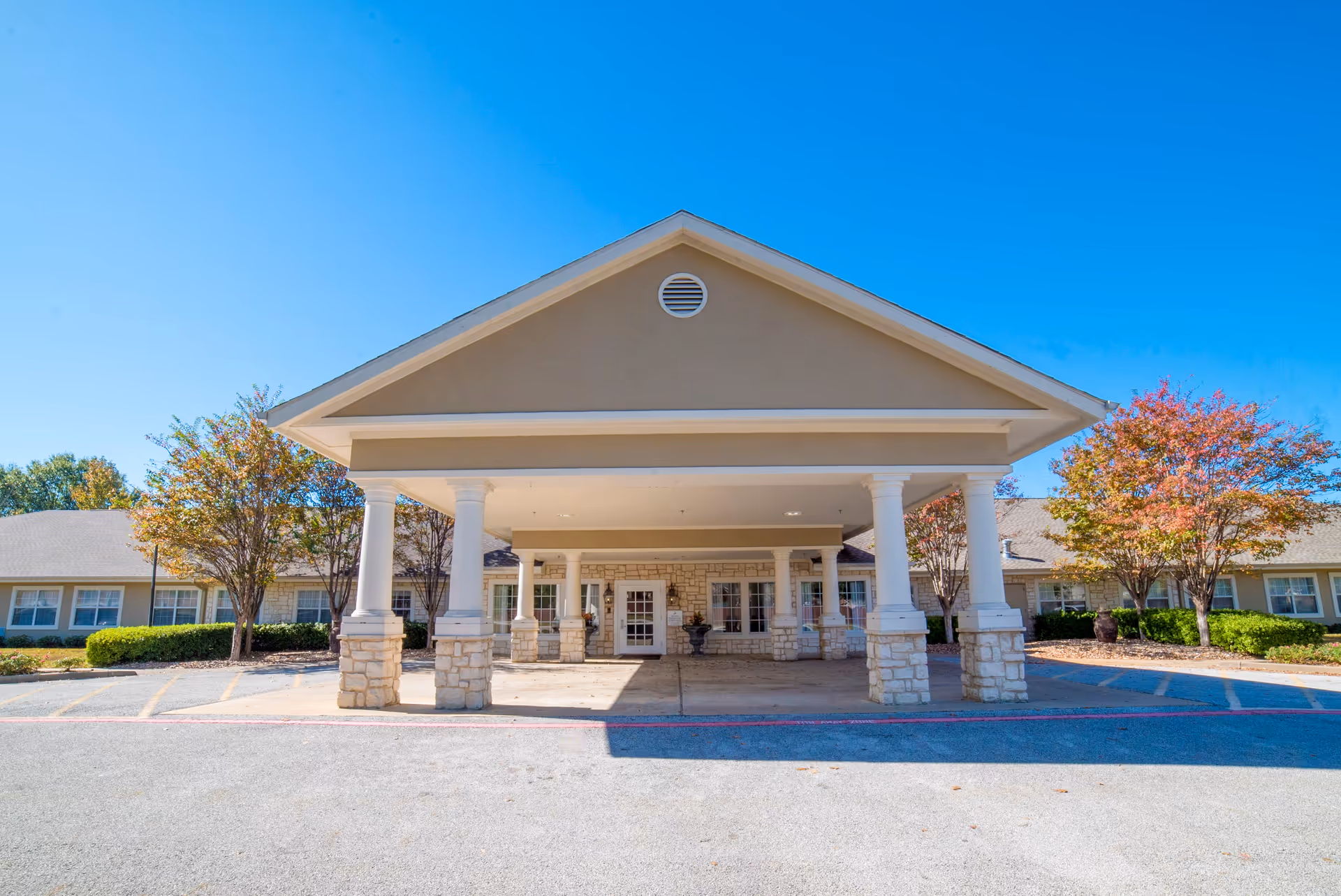 Front entrance of Brookdale Tyler South senior living facility with a porte-cochere and columns.