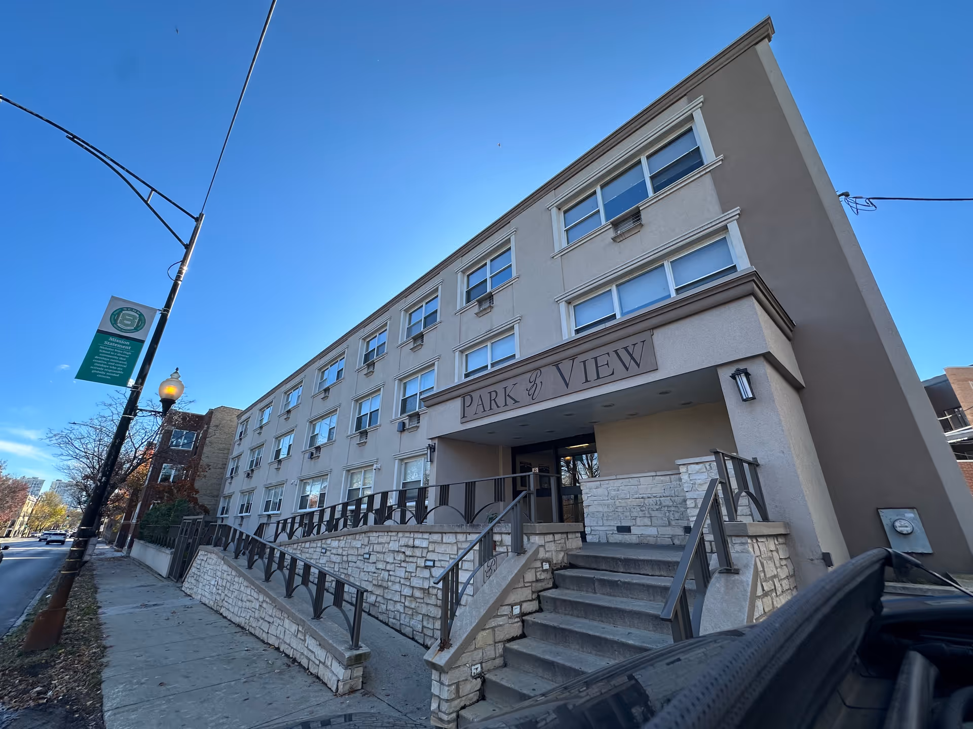 Street-level view of the Park View Rehab Center building exterior showing the entrance steps and ramp under a clear blue sky.