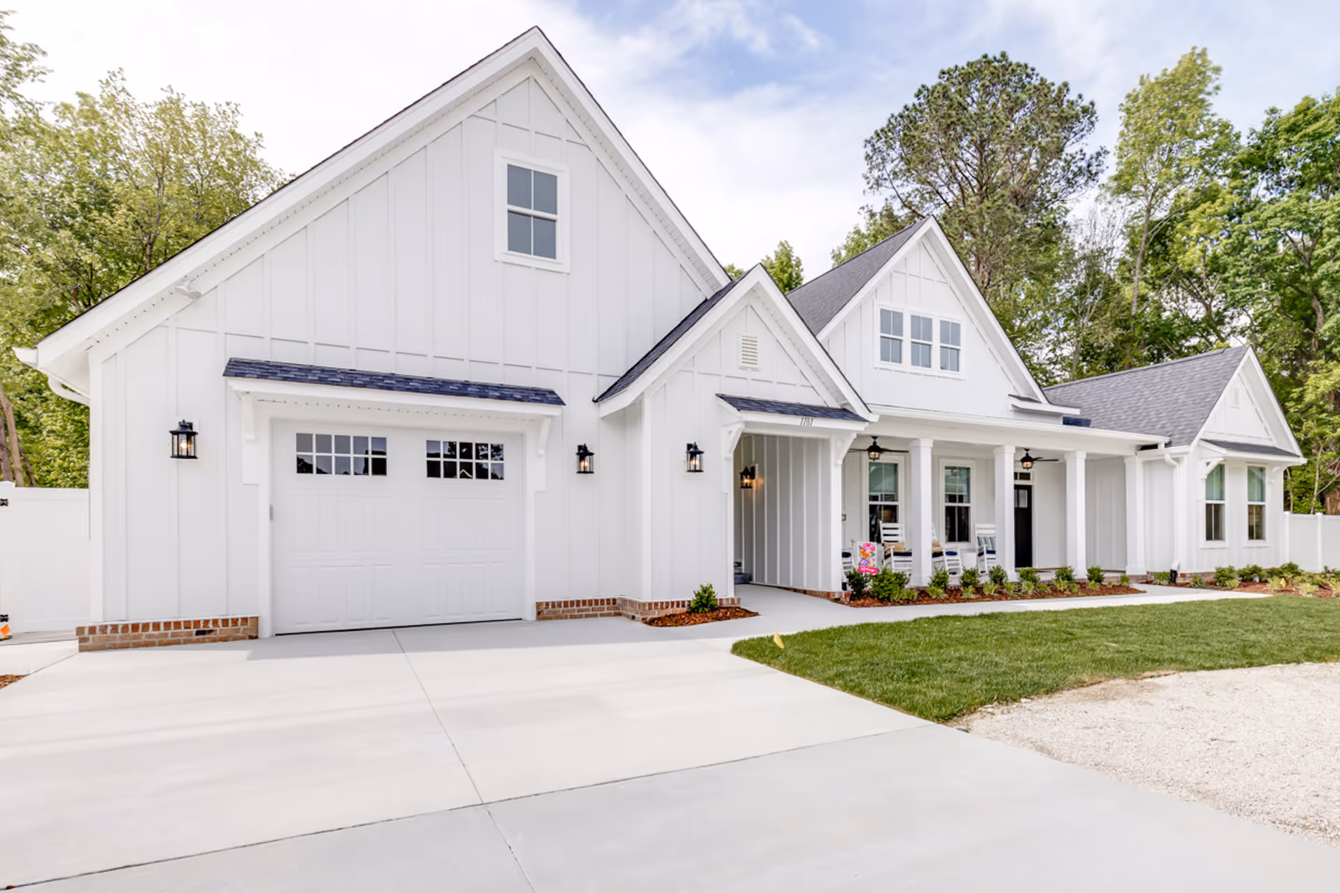 White modern senior living facility exterior with gabled roof and front entrance