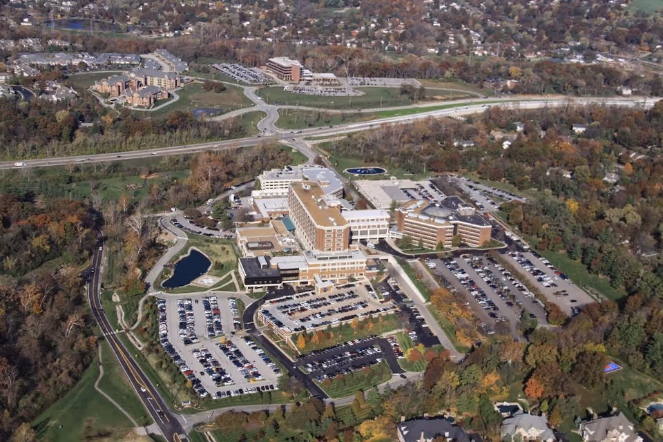 Aerial view of a large senior living campus with multiple connected buildings and parking.