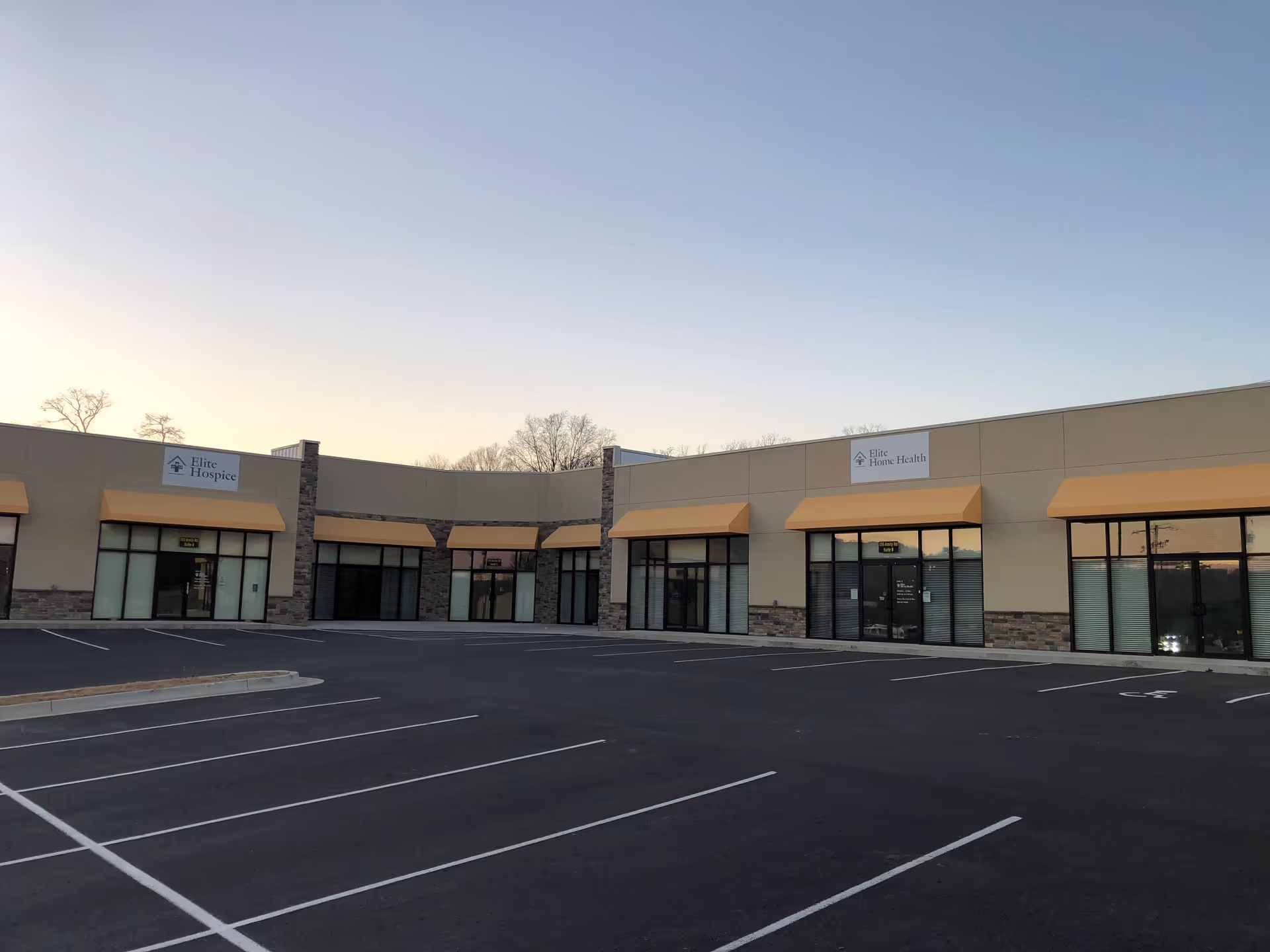 Exterior view of Elite Home Health of Hot Springs facility with tan awnings.