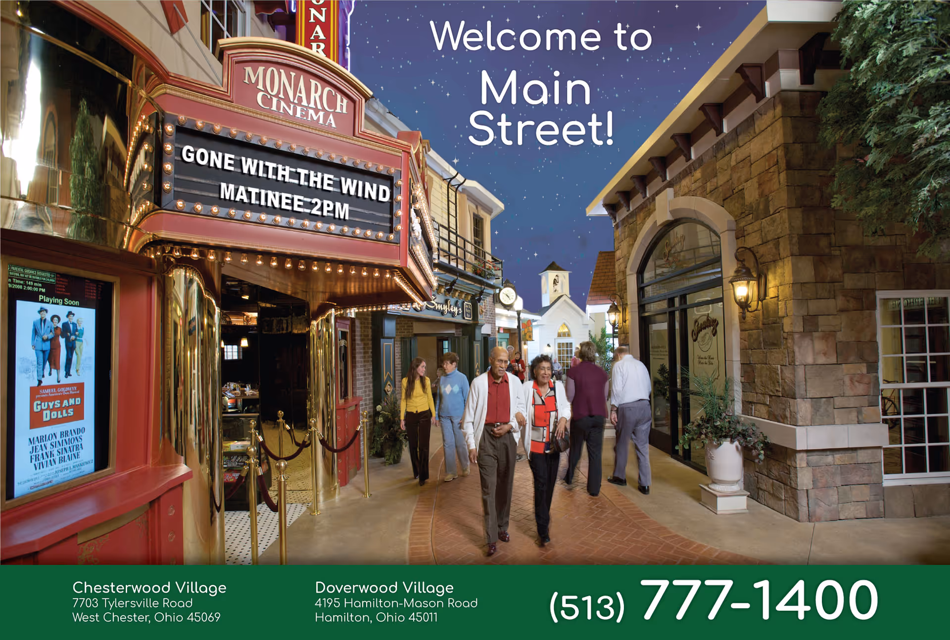 Indoor Main Street–style corridor with a theater marquee, storefronts and senior residents walking under a 'Welcome to Main Street!' sign.