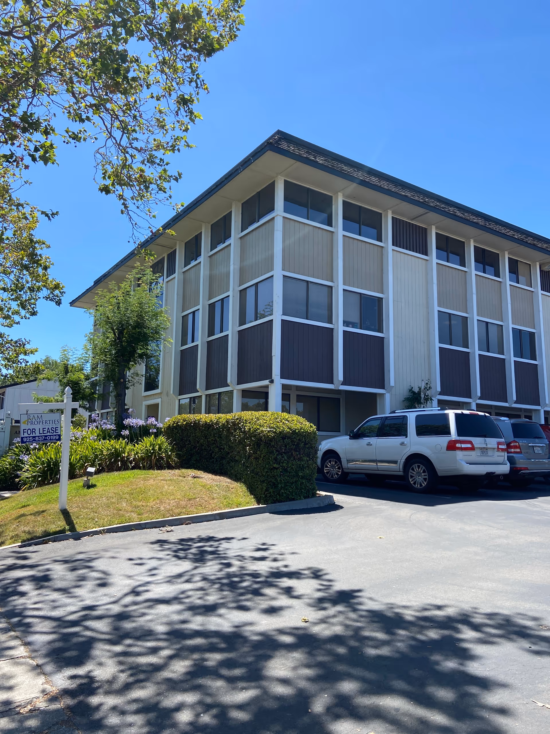 Exterior view of Care Plus Provider senior living building with cars in parking lot.