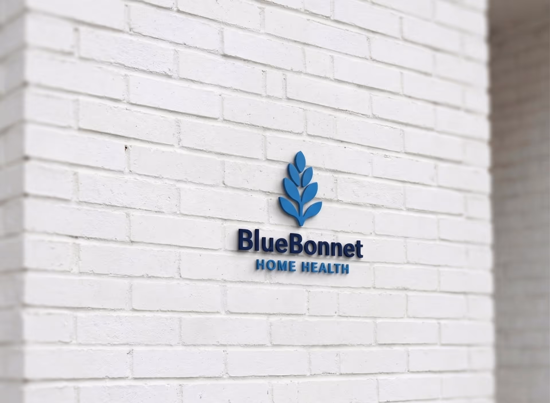 BlueBonnet Home Health sign mounted on a white brick exterior wall.
