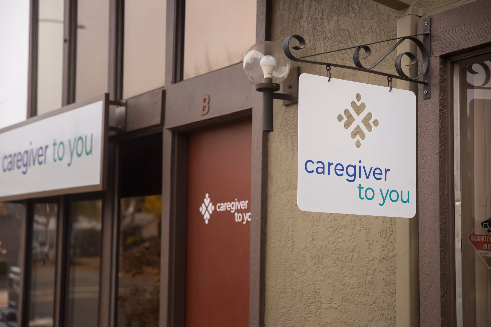 Exterior storefront signs for Caregiver To You on the building front.