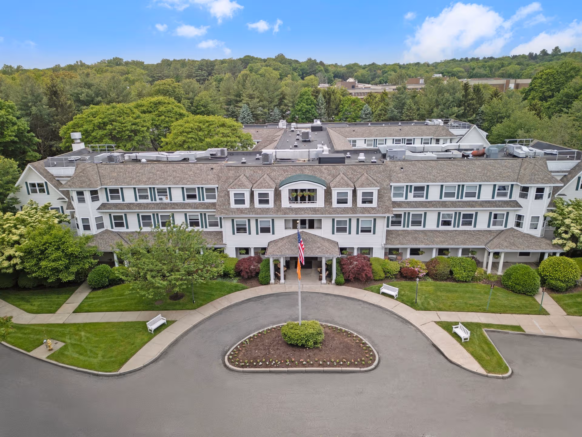 Aerial view of Brighton Gardens of Stamford exterior with circular driveway and landscaping